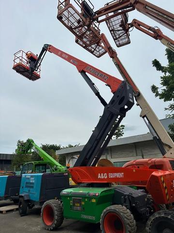 Electric articulating boom lift raised to full height at the yard in Johor
