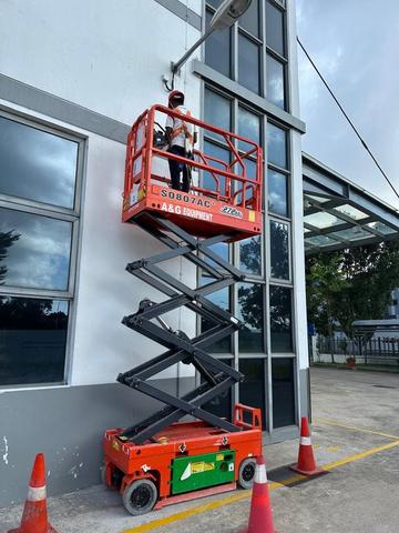 Electric scissor lift raised for M&E ceiling work in Johor Bahru