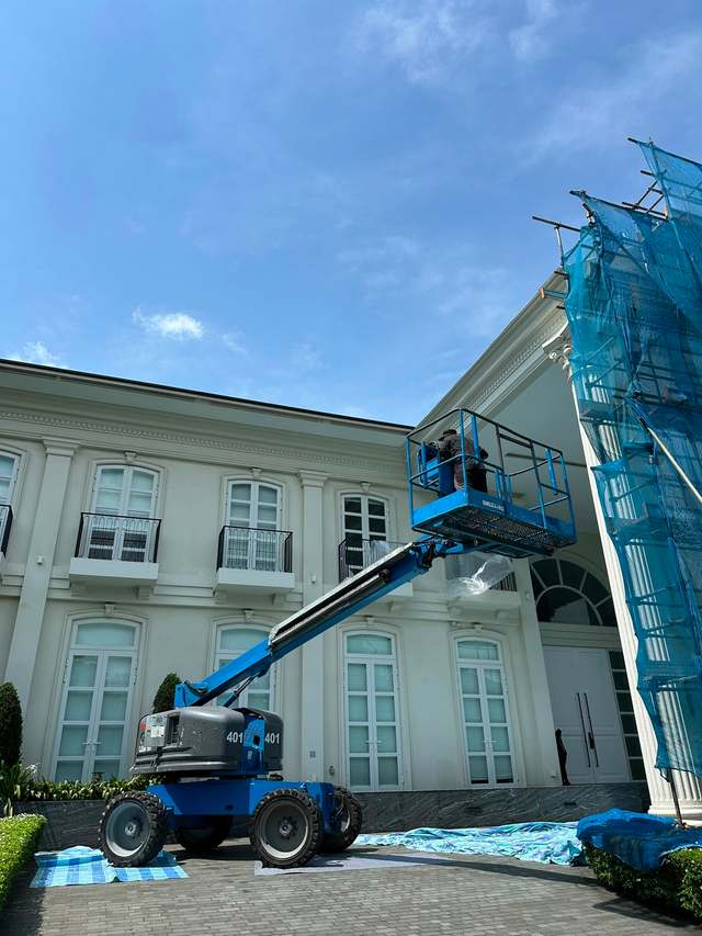 Genie articulating boom lift working on a bungalow facade in Johor