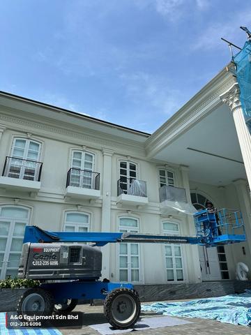 Genie boom lift reaching the upper facade of a bungalow, Johor