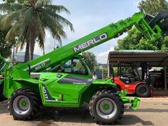 Merlo Panoramic 40.17 telehandler with boom raised next to an EP forklift at an equipment yard – rental in Johor