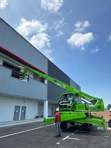 Merlo Roto rotating telehandler placing materials onto an upper floor in Johor