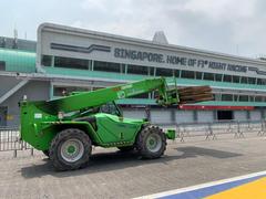 Merlo telehandler carrying a stack of timber boards on its forks – telehandler rental for Johor sites